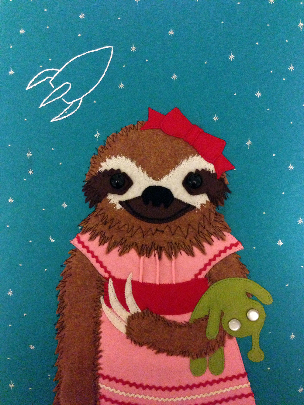 felt portrait of a sloth with an alien doll